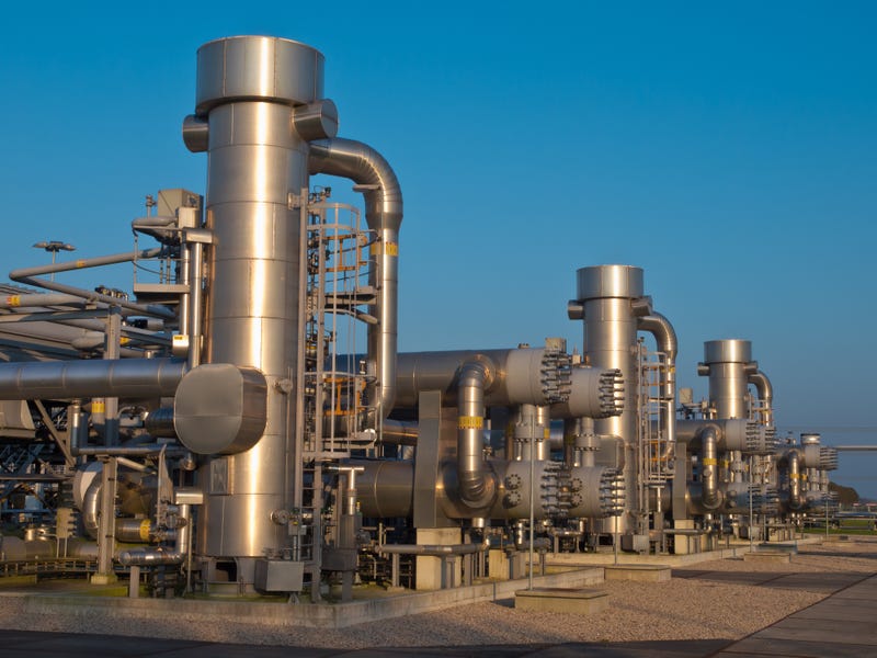 A modern natural gas processing plant during sunset
