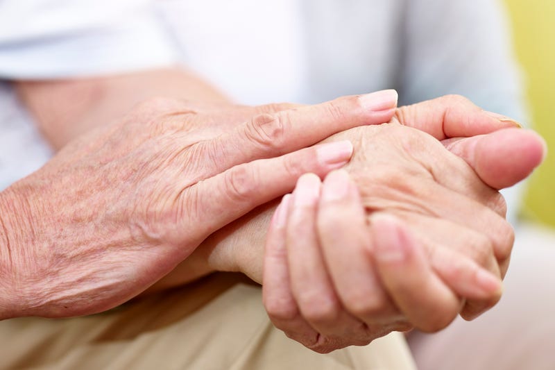 Elderly couple holding hands