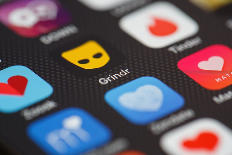 The Grindr app logo is seen among other dating apps on a mobile phone screen.