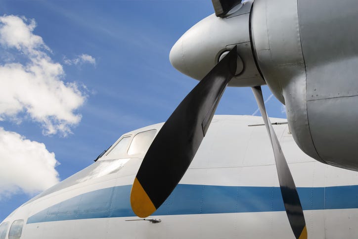 Close up of airplane turboprop engine with propeller.