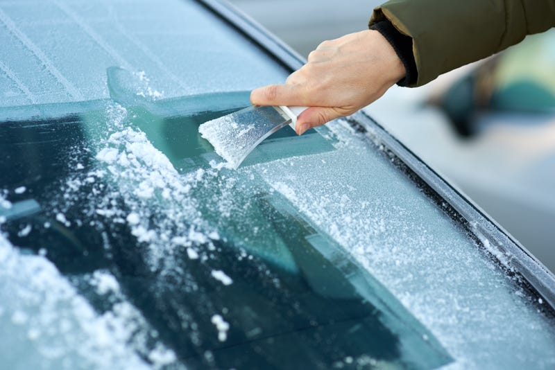 Scraping ice from a windshield
