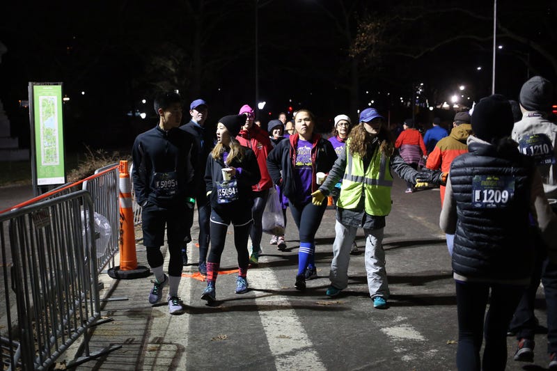 aPeople take part in the New York Road Runners Midnight Run through Central Park