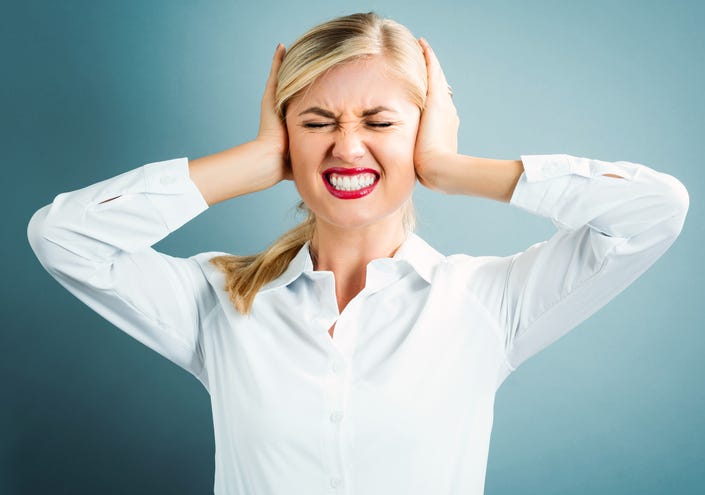 Woman plugging her ears