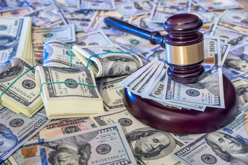 Gavel on top of $100 bills