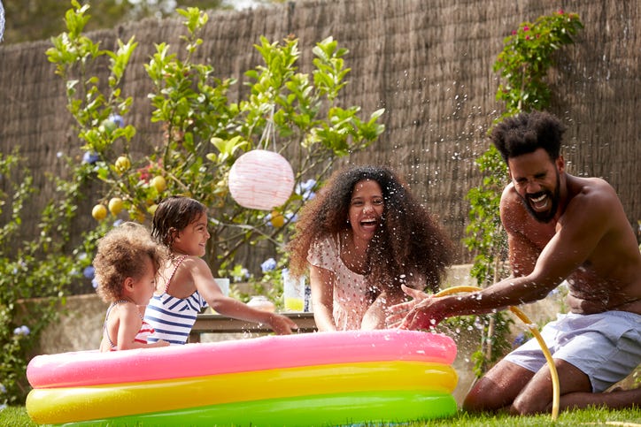 family playing games in backyard