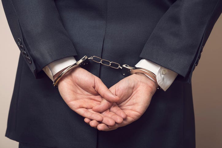 man in business suit arrested