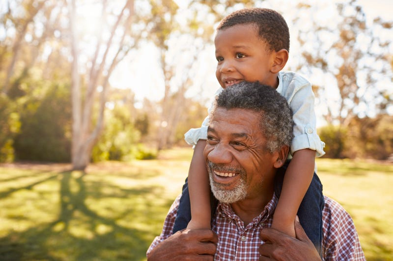 a grandfather and grandchild smiling
