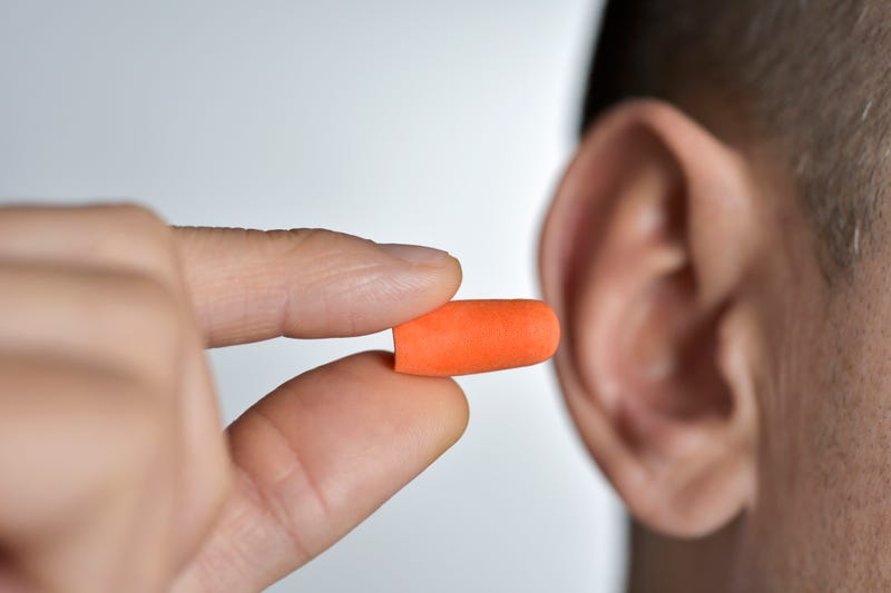 Man holding an earplug. 