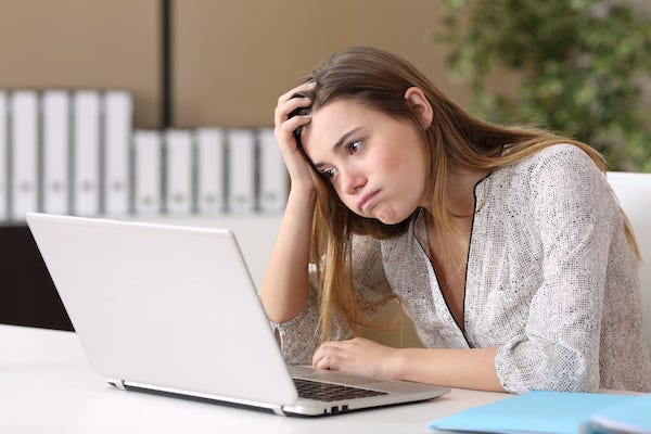 Frustrated woman staring at a computer