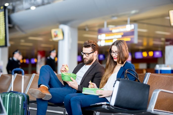 Couple eating while waiting at the airport