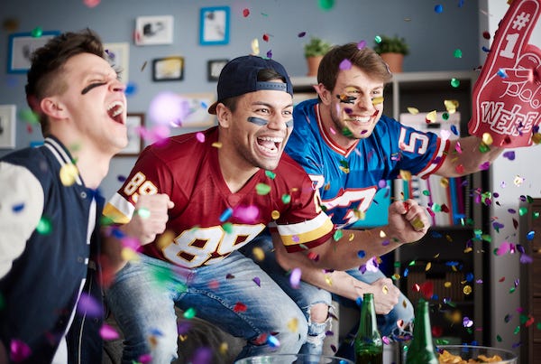 American football fans among falling confetti 