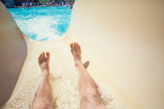 Man going down slide at waterpark