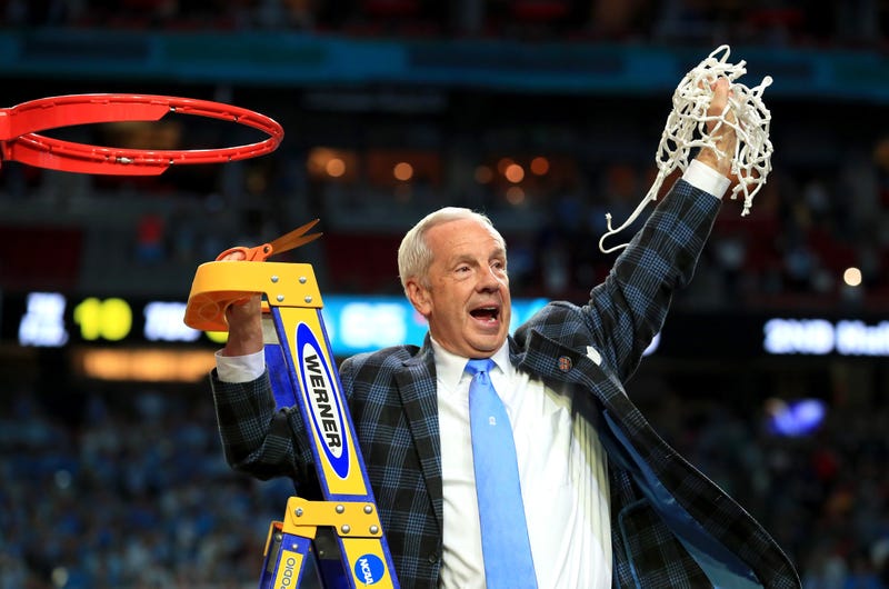 UNC head coach Roy Williams cuts down the nets.