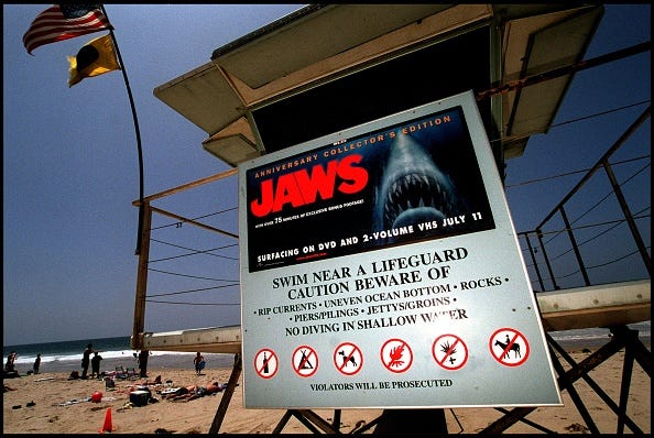 A poster advertising the anniversary collector's edition of the movie "Jaws" is posted on a lifeguard tower June 2, 2000 on Zuma Beach in Malibu, CA. The sign has led to complaints by beach goers with young children, who feel that it is inappropriate for the sign to be on display so close to the water and so near the 4th of July. (Photo by Dan Callister/Newsmakers).
