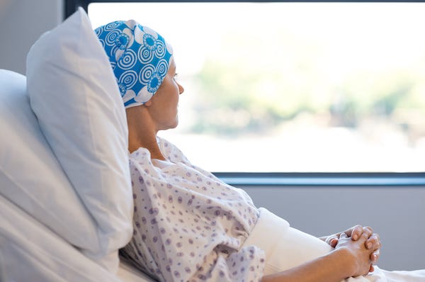 Female cancer patient laying in hospital bed