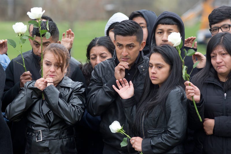 Family and friends say goodbye to Justin Llivicura at his burial in a cemetery on April 19, 2017 in Coram