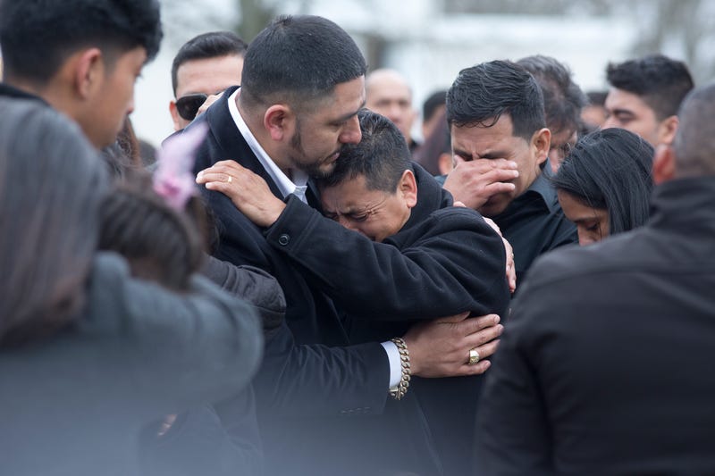 Family and friends say goodbye to Justin Llivicura at his burial in a cemetery on April 19, 2017 in Coram