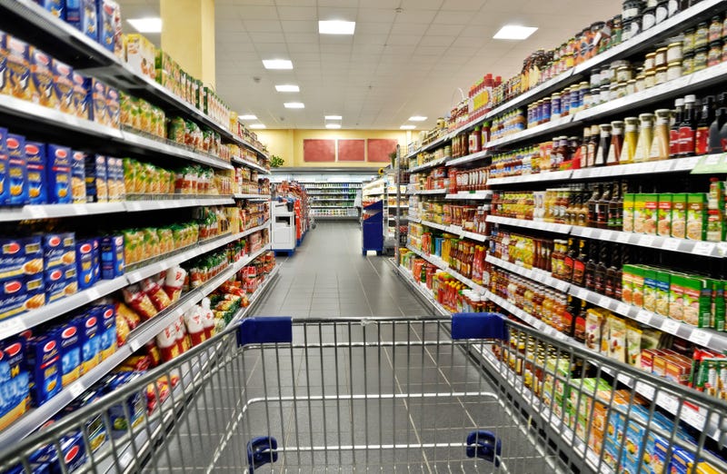 Shopping cart in grocery store aisle