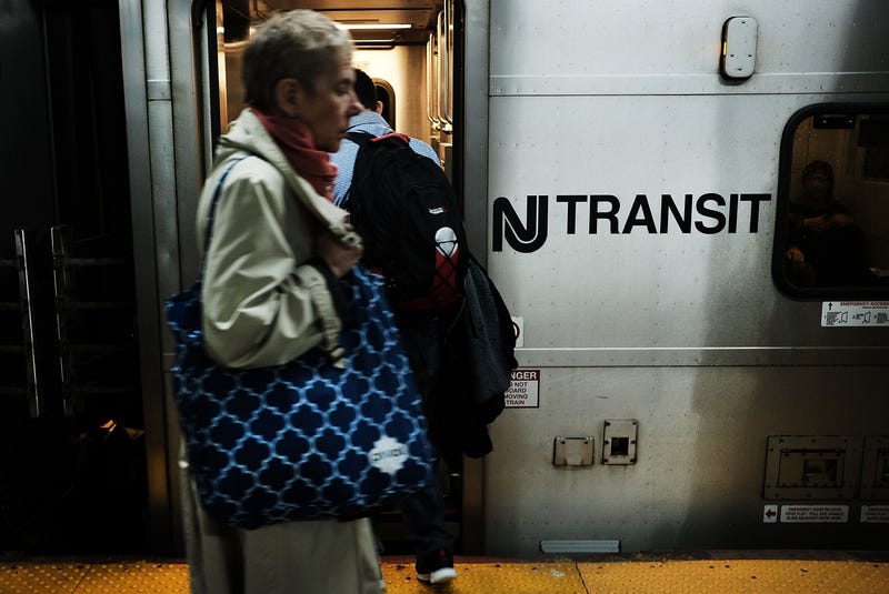 Passengers board a New Jersey Transit train at Pennsylvania Station