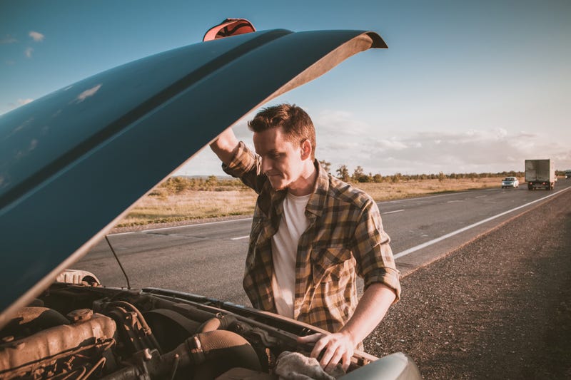 A man whose car has broken down. 