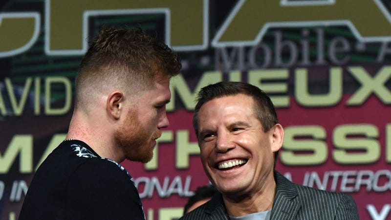 Boxer Canelo Alvarez (L) greets former boxer Julio Cesar Chavez Sr. 