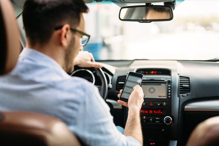 Man using phone while driving