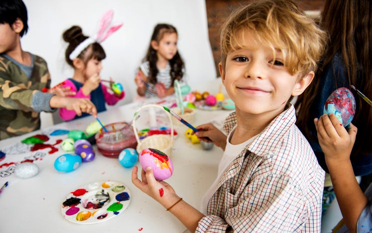 children painting easter eggs