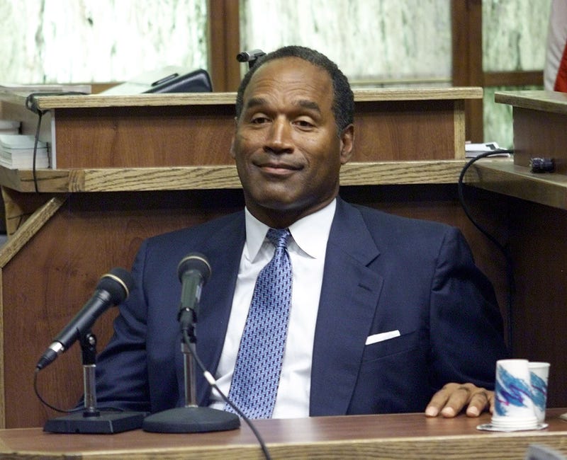 397272 06: (FILE PHOTO) Former NFL star and actor O.J. Simpson testifies in Miami-Dade County Court during his "road rage" trial October 23, 2001 in Miami, Florida. U.S. Federal agents searched Simpson's home near Miami December 4, 2001 during an investigation into an Ecstasy drug ring and the theft of equipment used to steal satellite television signals. Simpson had not been arrested or indicted. (Pool Photo/Getty Images)