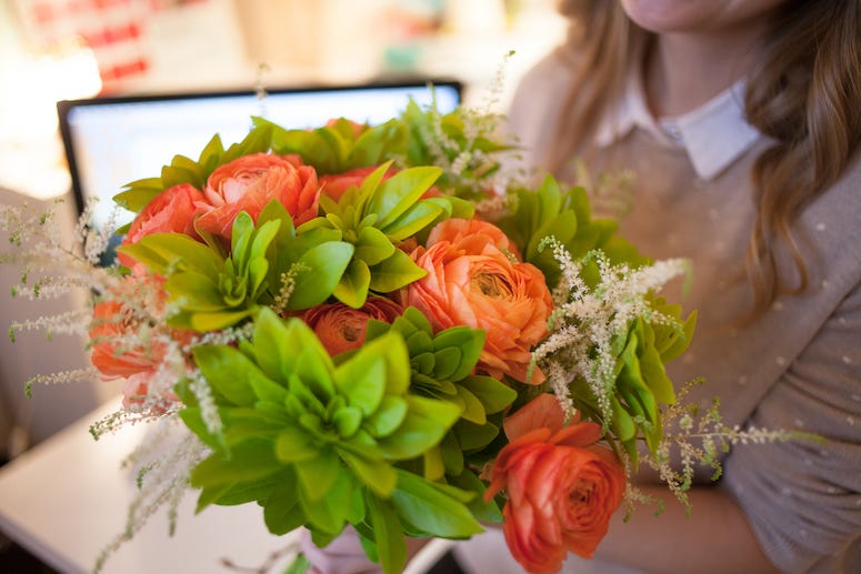 Woman holding flowers, office flower delivery, computer