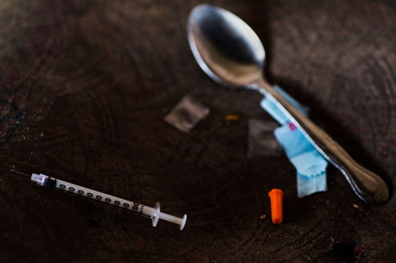 needle, spoon, and narcotics bag