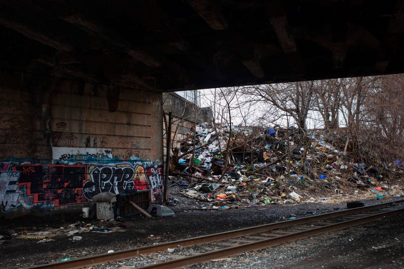 Household trash and graffiti are seen under a bridge near in Kensington, Philadelphia. 