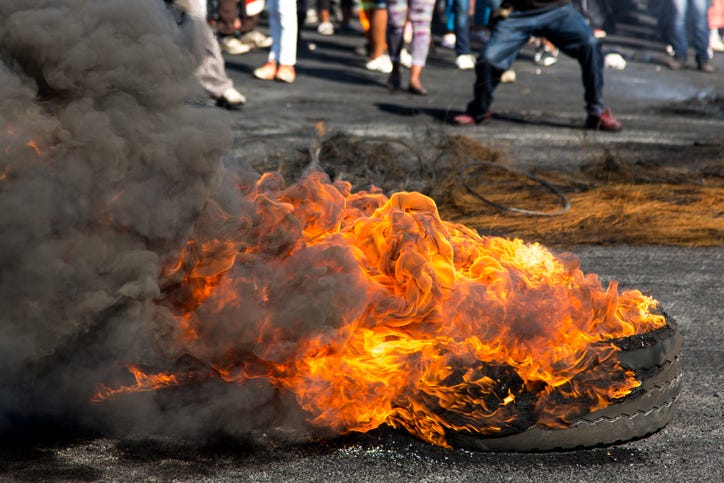 Tire burning white people protest.