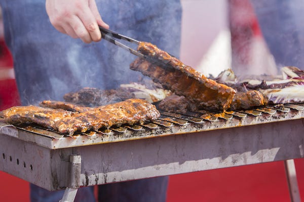 Chef cooking ribs on the grill