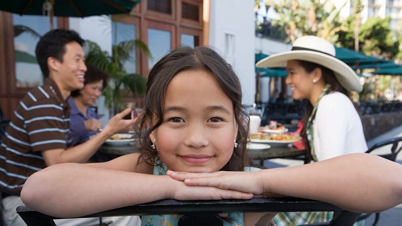 Parents and kids dining on a restaurant patio