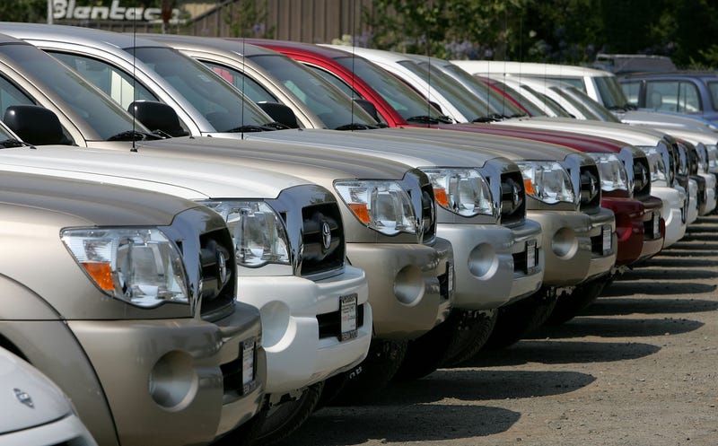 Toyota is recalling 393,838 trucks and SUVs after discovering a software defect in the rearview camera display that may render the view blank or green when drivers back up.