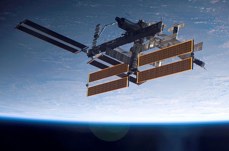 In this handout photo provided by NASA, the International Space Station is seen over a blue and white Earth, taken shortly after the Space Shuttle Atlantis undocked from the orbital outpost at 7:50 a.m. CDT. The unlinking completed six days, two hours and two minutes of joint operations with the station crew. Atlantis left the station with a new, second pair of 240-foot solar wings, attached to a new 17.5-ton section of truss with batteries, electronics and a giant rotating joint. The new solar arrays eventually will double the station's onboard power when their electrical systems are brought online during the next shuttle flight, planned for launch in December. (Photo by NASA via Getty Images)