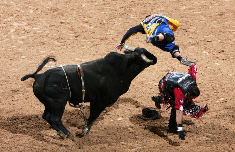 World Champion Guilherme Marchi of Brazil is thrown from his ride as bullfighter Joe Baumgartner is tossed by Jumpin Jack Flash during the Professional Bull Riders World Finals at Mandalay Bay Casino and Hotel October 29, 2006 in Las Vegas, Nevada.