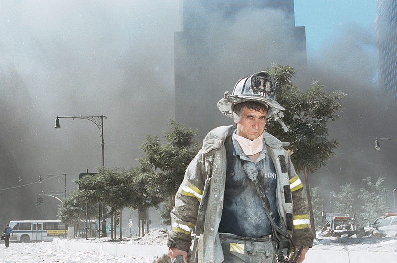An unidentified New York City firefighter walks away from Ground Zero after the collapse of the Twin Towers Sept. 11, 2001.