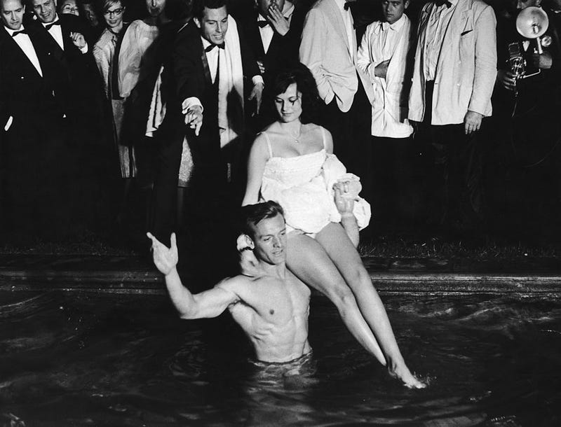 Guests recreate a classic scene from 'La Dolce Vita' at a party given by French photographer Louis Dalmas during the Cannes Film Festival, to honour the film's release, 10th May 1960. (Photo by Keystone/Hulton Archive/Getty Images)