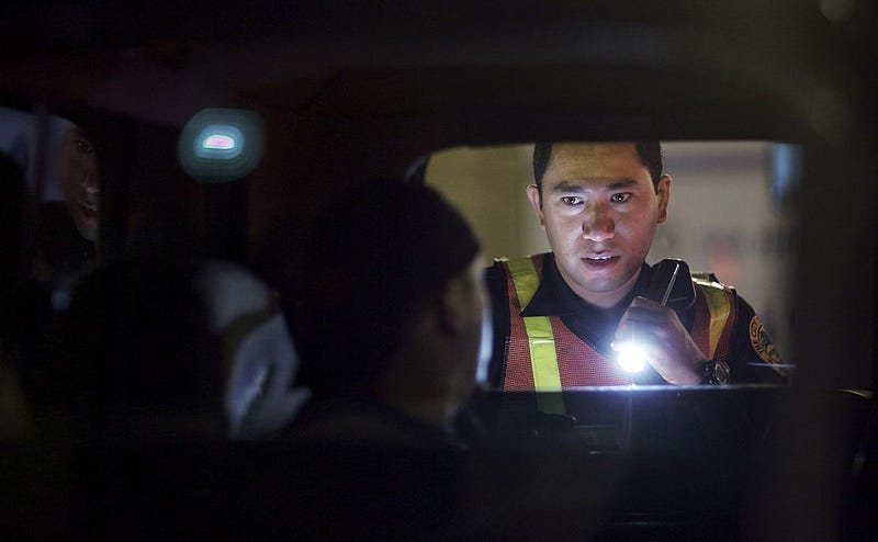 Officer checks in on a driver during a DUI checkpoint