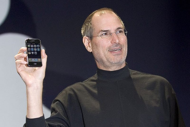 Apple CEO Steve Jobs holds up the new iPhone that was introduced at Macworld on January 9, 2007 in San Francisco, California. During the keynote Jobs introduced the new iPhone which will combine a mobile phone, a widescreen iPod with touch controls and a internet communications device with the ability to use email, web browsing, maps and searching. The iPhone will start shipping in the US in June 2007. (Photo by David Paul Morris/Getty Images)