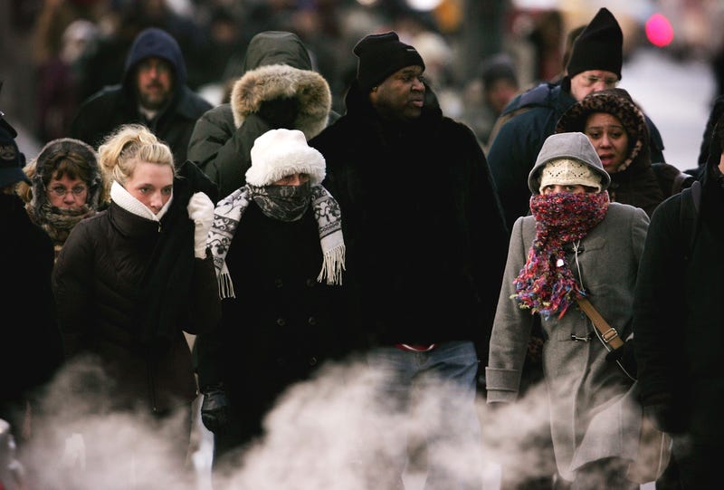 Commuters are bundled for protection from the sub-zero cold as they head to work