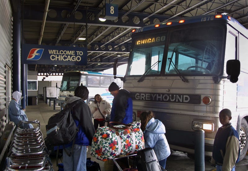 Passengers outside a Greyhound bus at the city's bus terminal. 