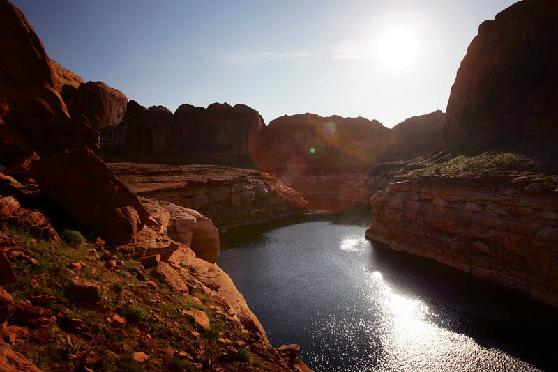 The sun rises over the low lake level, the result of a six-year drought that has dramatically dropped the level of the reservoir, in Llewellyn Gulch canyon on March 28, 2007 near Page, Arizona.