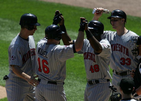 Jason Kubel #16 of the Minnesota Twins is greeted by teammates Joe Mauer #7, Torii Hunter #48 and Justin Morneau #33 after hitting a grand slam home run in the 4th inning against the Chicago White Sox on July 6, 2007 at U.S. Cellular Field in Chicago, Illinois.