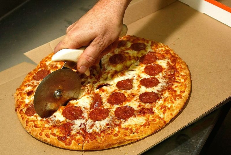 Cutting into a Little Caesars pizza