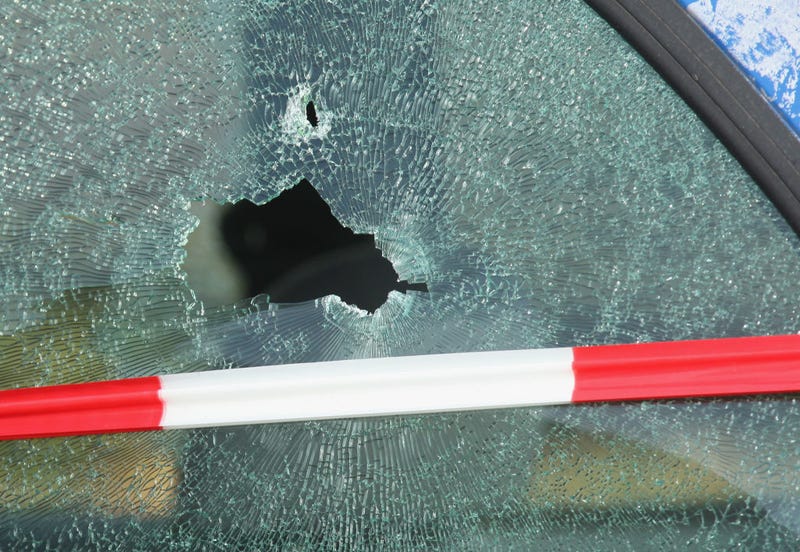 The shattered window of a car struck by a bullet is visible outside a branch of Postbank bank after an attempted robbery that left one guard dead October 29, 2007 in Berlin, Germany.