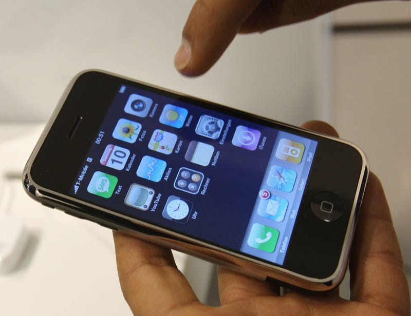 A young man checks out an Apple iPhone at a T-Mobile shop on the first day the mobile phone went on sale November 9, 2007 in Berlin, Germany. 