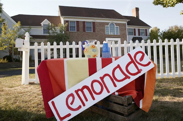 Lemonade stand in front of a house