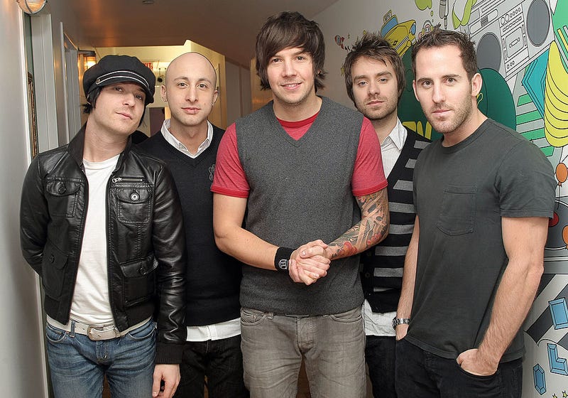 David Desrosiers, Jeff Stinco, Pierre Bouvier, Sebastien Lefebvre, and Chuck Comeau of Simple Plan pose for a photo backstage during MTV's Total Request Live at the MTV Times Square Studios December 10, 2007 in New York City